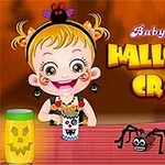 Ένα χαμογελαστό παιδί με στολή για το Halloween κάθεται σε τραπέζι με χειροτεχνίες και διακοσμητική αράχνη