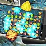 Smartphone με οθόνη γεμάτη πολύχρωμα πετράδια, ένα μπλε κρανίο με κόκκινα μάτια, και χρυσά διαμάντια γύρω του