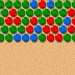 Κόκκινες, μπλε και πράσινες σφαίρες τοποθετημένες σε σειρές πάνω σε μπεζ φόντο